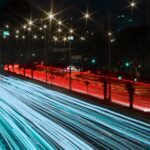 a long exposure photo of a highway at night