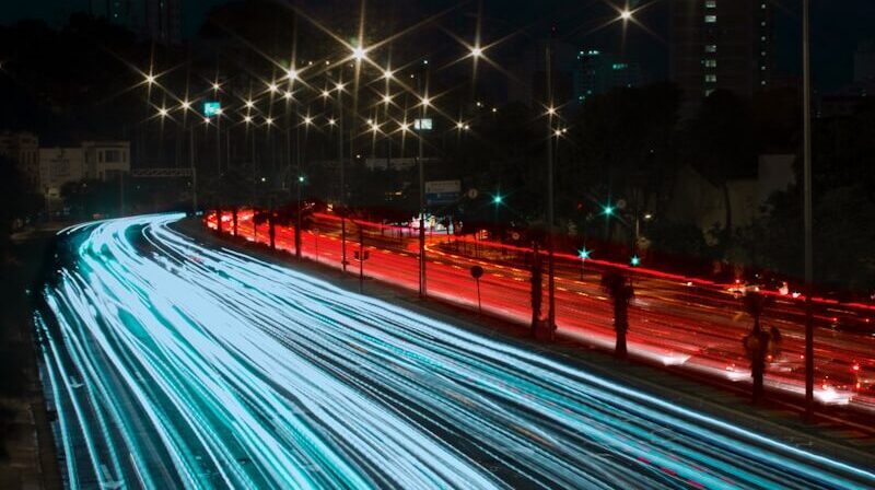 a long exposure photo of a highway at night